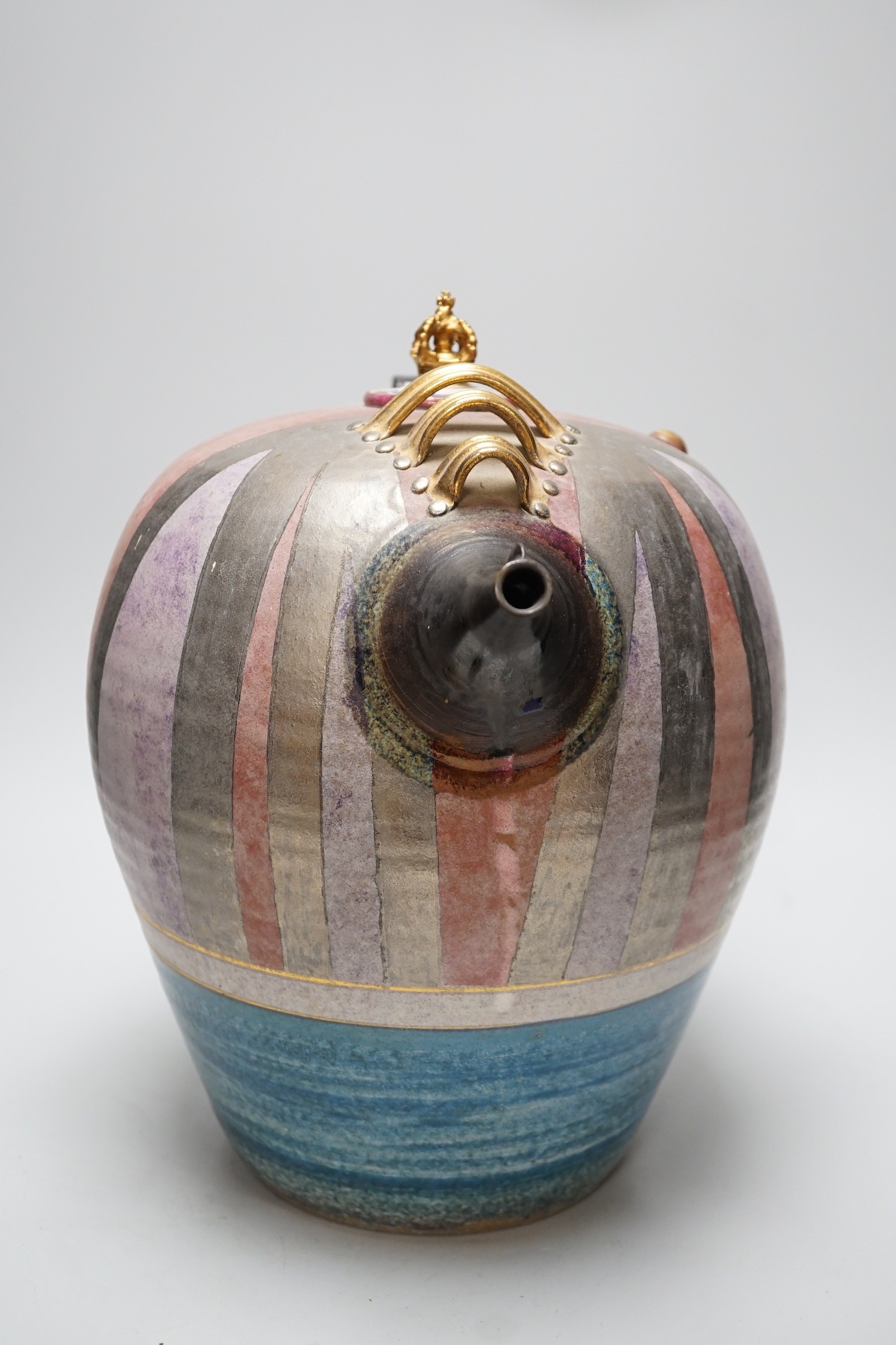 A Doug Bignell 'Mad Hatter's Tea Party' teapot and a hand needle worked tea cosy, inscribed “Nice drop of regimental sergeant majors”(specially commissioned by the current owner), teapot 35cms high